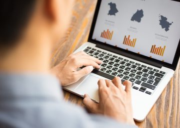 Businessman watching financial report on laptop